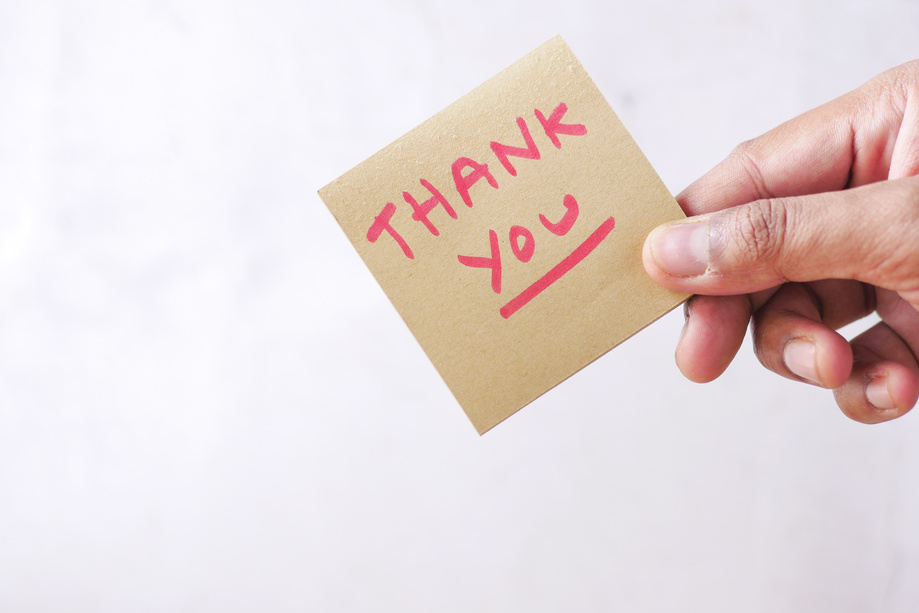 Hand Holding Thank You Note with Copy Space
